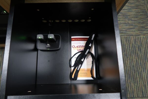 Pedestal - inside view of drawer showing two wireless mics in charging base