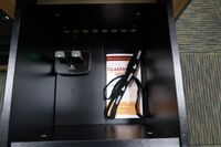 Pedestal - inside view of drawer showing two wireless mics in charging base