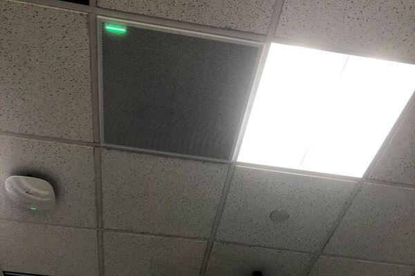 White 2¿ x 2¿ tile mounted in the ceiling to provide microphone coverage over student seating