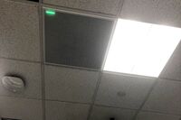 White 2¿ x 2¿ tile mounted in the ceiling to provide microphone coverage over student seating