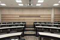 Back of room view of student tiered fixed-table and chair seating 