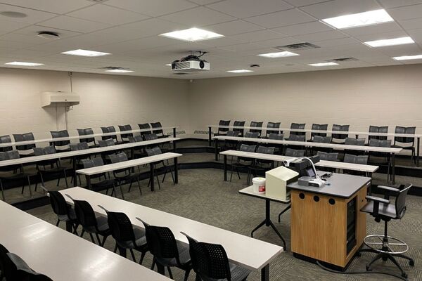 Back of room view of student tiered fixed table and chair seating