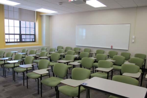 Back of room view of student tablet arm seating and markerboard on back wall