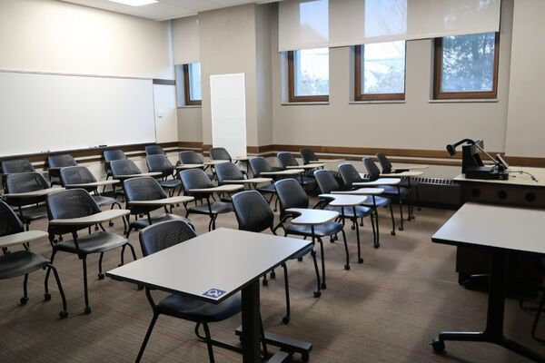 Back of room view of student tablet arm seating and markerboard at rear of room