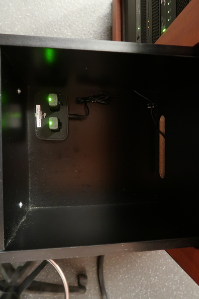 Pedestal - inside view of drawers showing two wireless mics in charging base