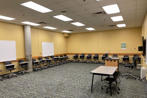 Back of room view of student tablet arm seating and markerboards on rear wall