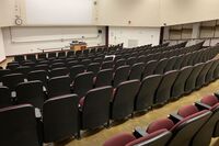 Front of room view with lectern on right in front of markerboard 