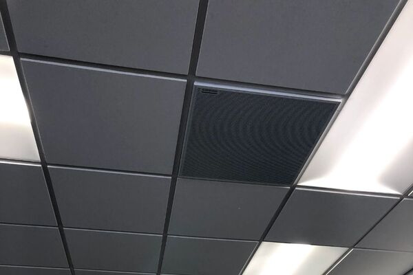 White 2¿ x 2¿ tile mounted in the ceiling to provide microphone coverage over student seating