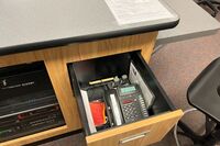  Pedestal - inside view of drawer showing two wireless mics in charging base and telephone