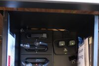  Pedestal - inside view of drawer showing two wireless mics in charging base and assistive listening devices in charger