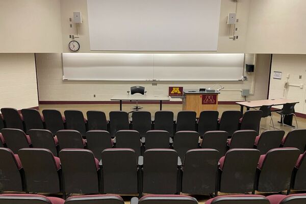 Front of room view with lectern on right in front of markerboard