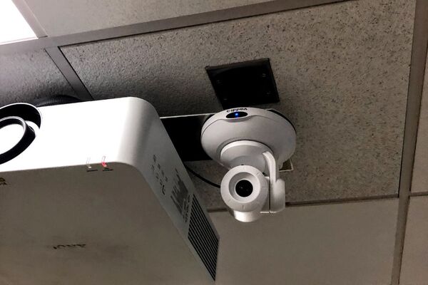 Camera mounted to ceiling) and instructor enabled adjustments to the lens to allow the instructor to be "seen" by the camera in more locations around the room