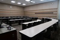 Back of room view of student fixed-table and chair seating 